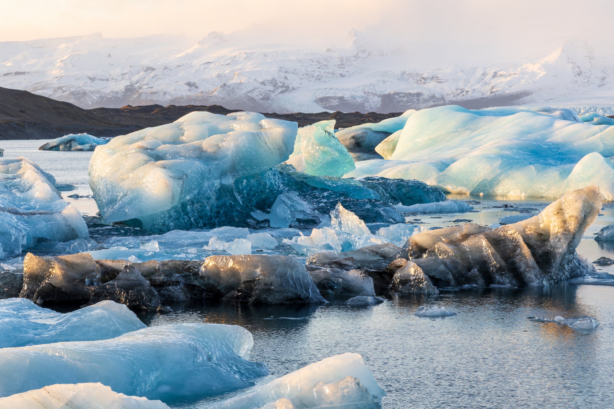 Blue glacial ice in a reflective lagoon